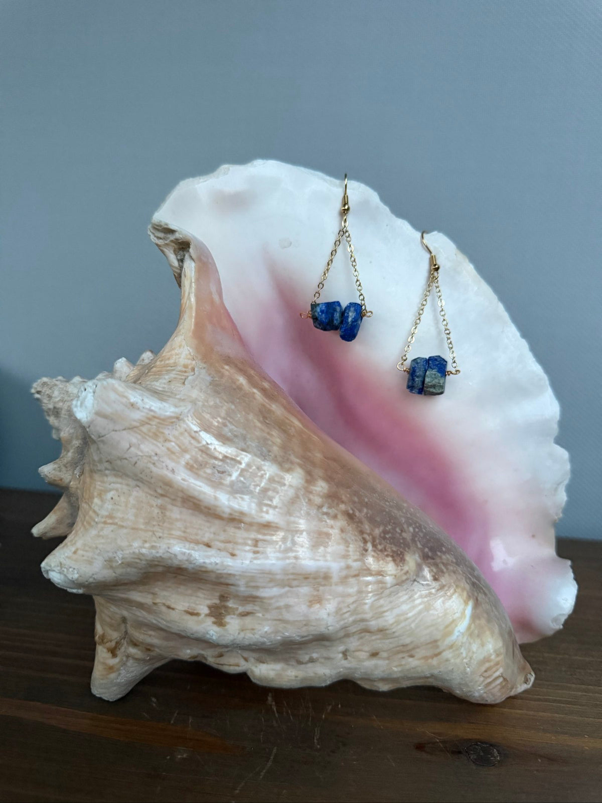 Nia Vintage Boutique blue drop earrings with raw lapis lazuli stones and gold-tone chains.