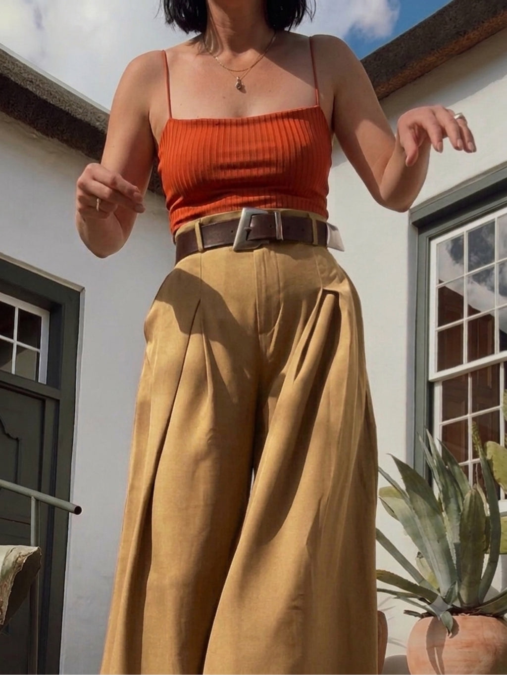 Rust ribbed crop top orange with spaghetti straps and textured fabric.