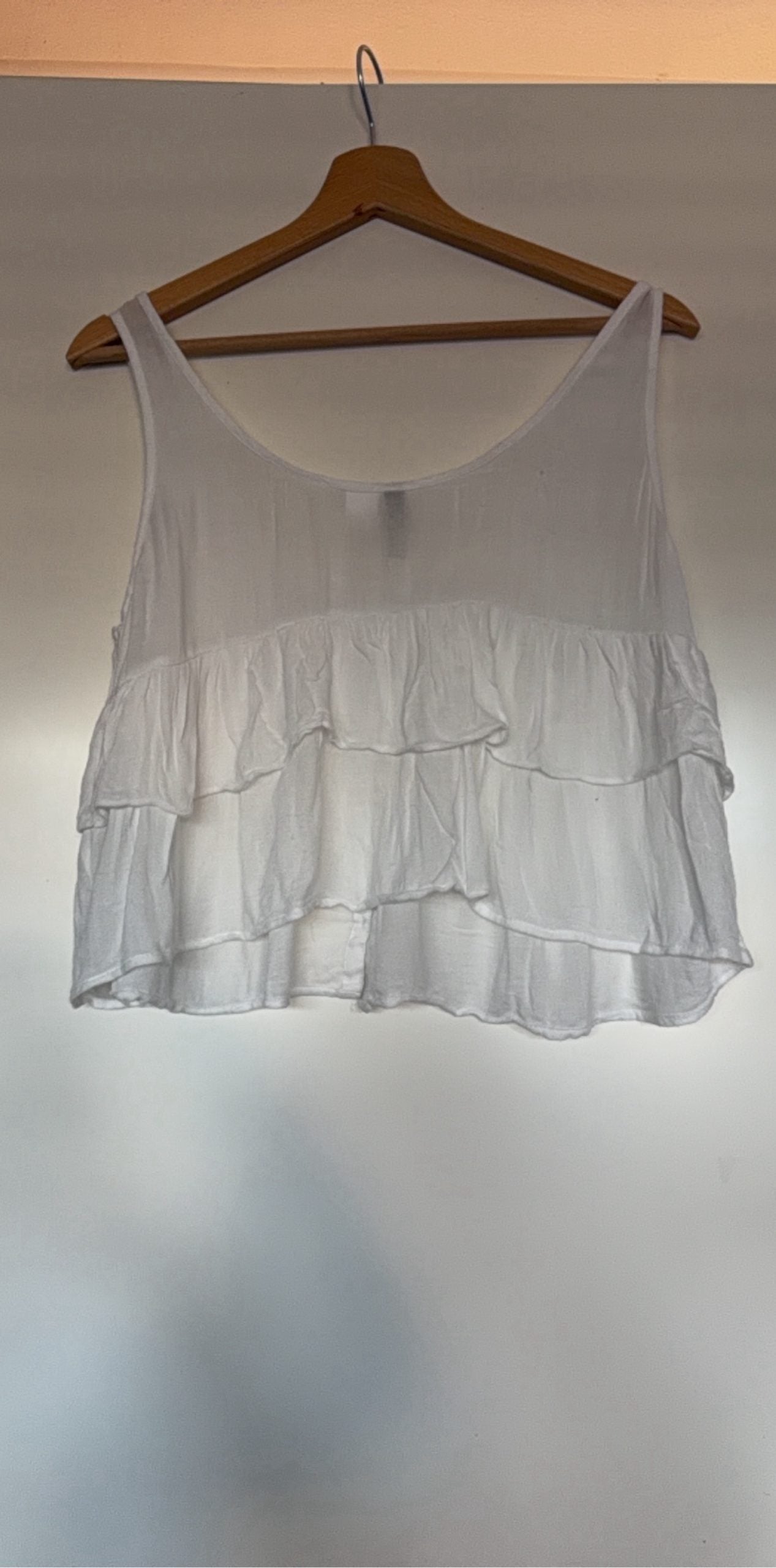 H&M white crop top with ruffled tiers and decorative button-up front.