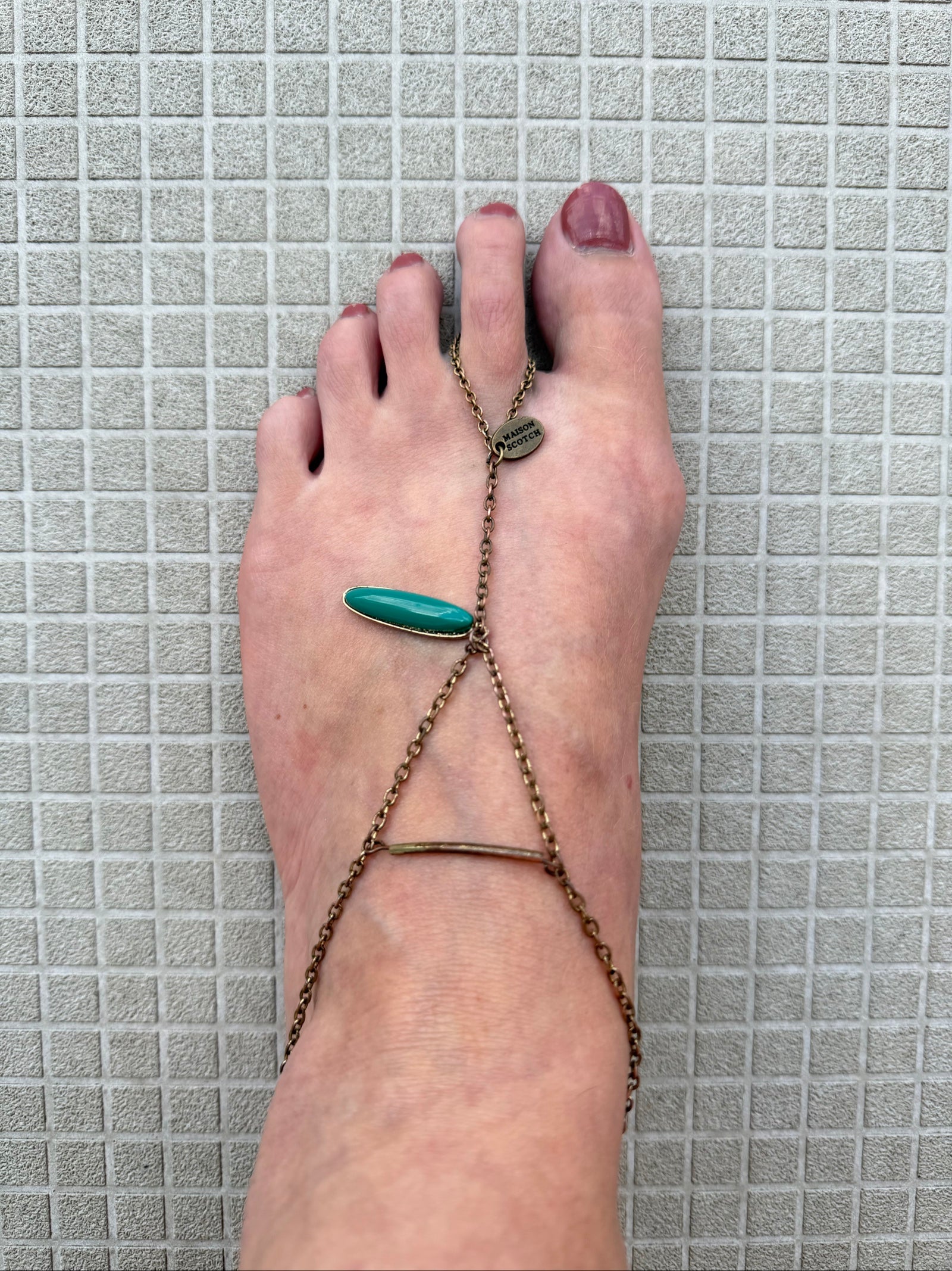 Festival foot chain jewelry in worn bronze with turquoise and green stones, artisan design.