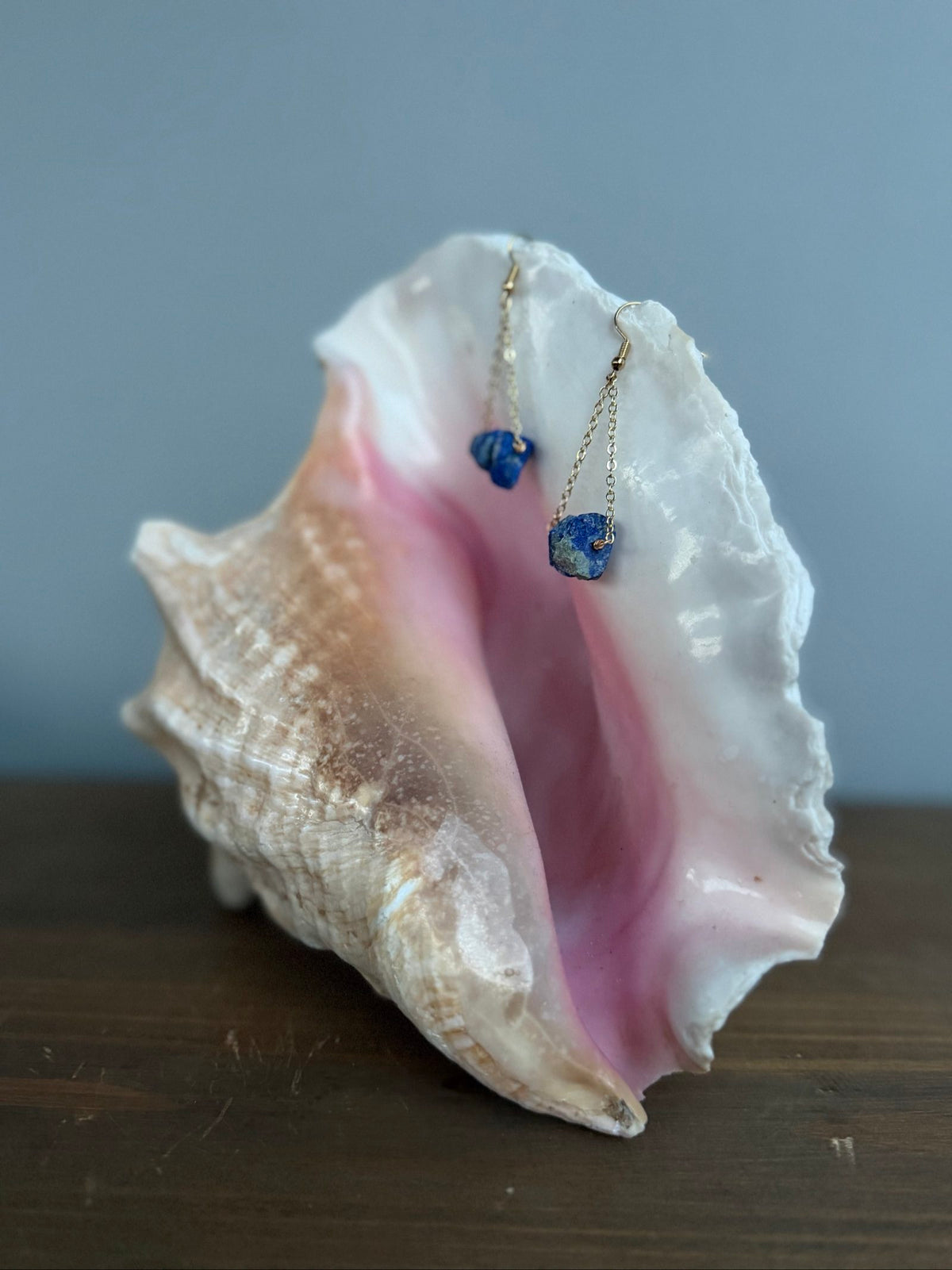 Nia Vintage Boutique blue drop earrings with raw lapis lazuli stones and gold-tone chains.