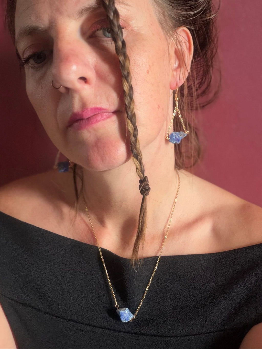 Nia Vintage Boutique blue earrings with raw lapis lazuli stones on gold chain.